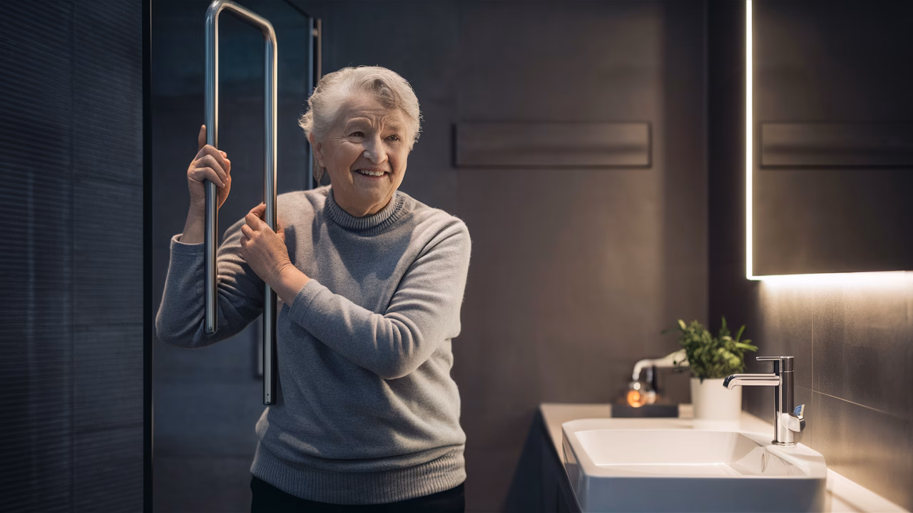 Secure grab bar for bathroom safety Elderly person using grab bar for support